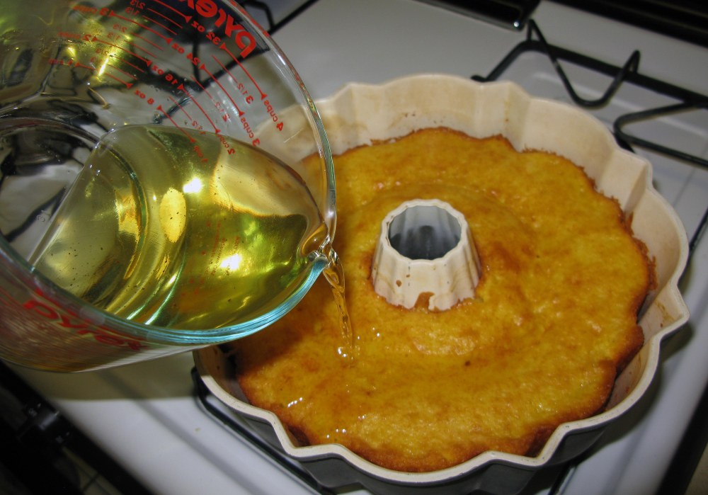 Pouring Syrup Over Lemon Cake